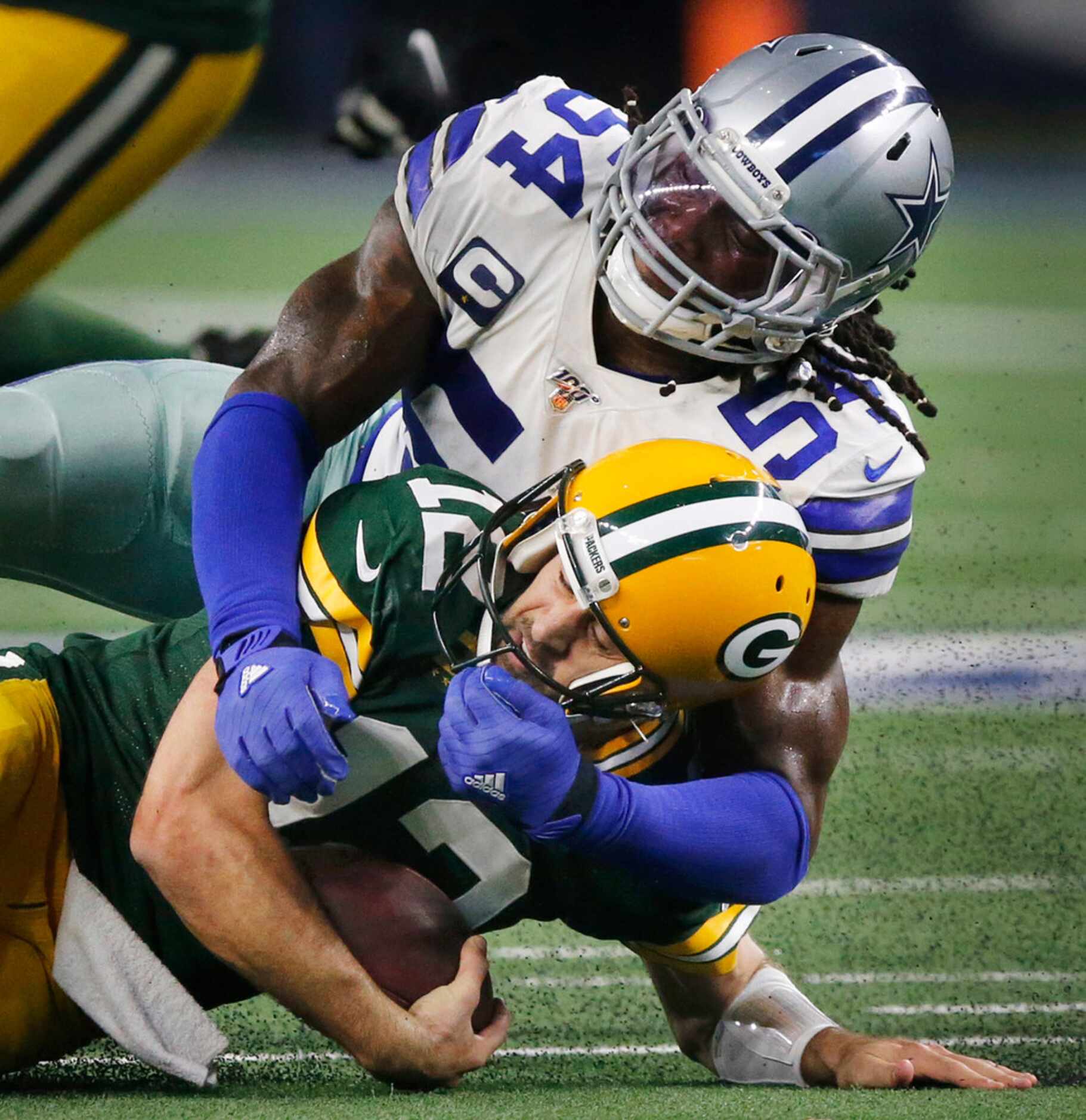 Dallas Cowboys middle linebacker Jaylon Smith (54) tackles Green Bay Packers quarterback...