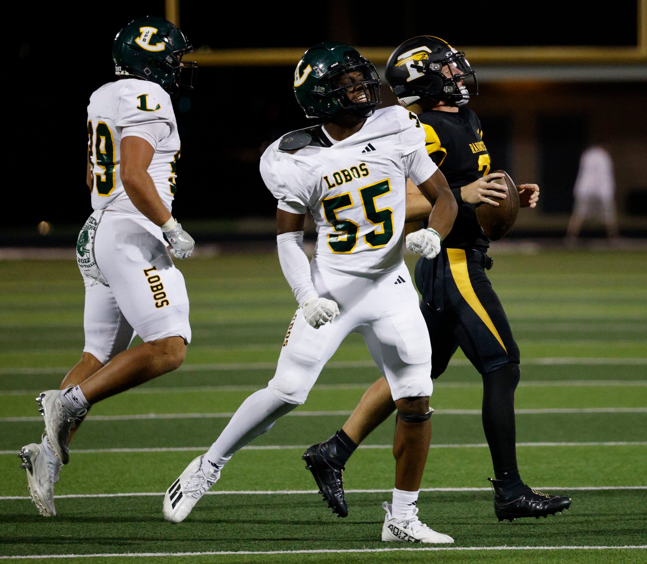 Longview's Xaryus Sheppard (55) and Longview's Billy Smith (99), react after they sacked...