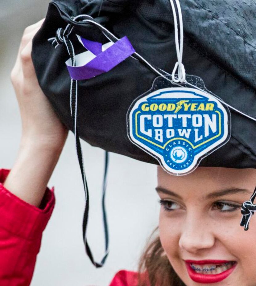 
One of the Kilgore Rangerettes took cover from the rain as she waited to enter AT&T Stadium...