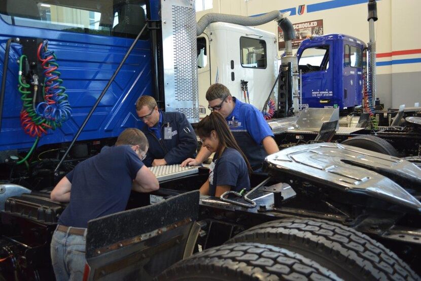  UTI students work on a truck.