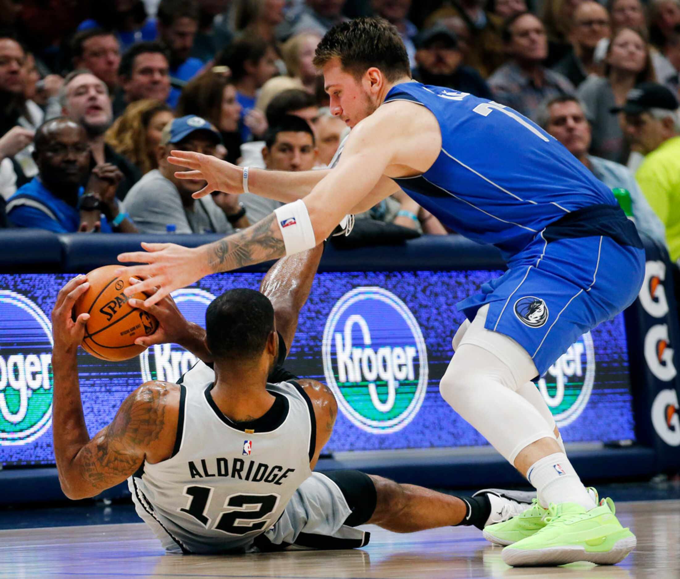 Dallas Mavericks forward Luka Doncic (77) tries to steal the ball from San Antonio Spurs...