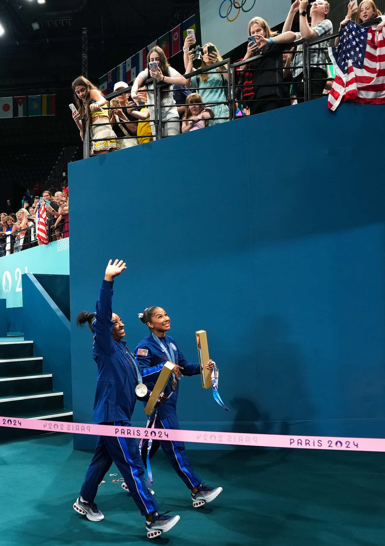 Silver medalist Simone Biles and bronze medalist Jordan Chiles of the United States wave to...