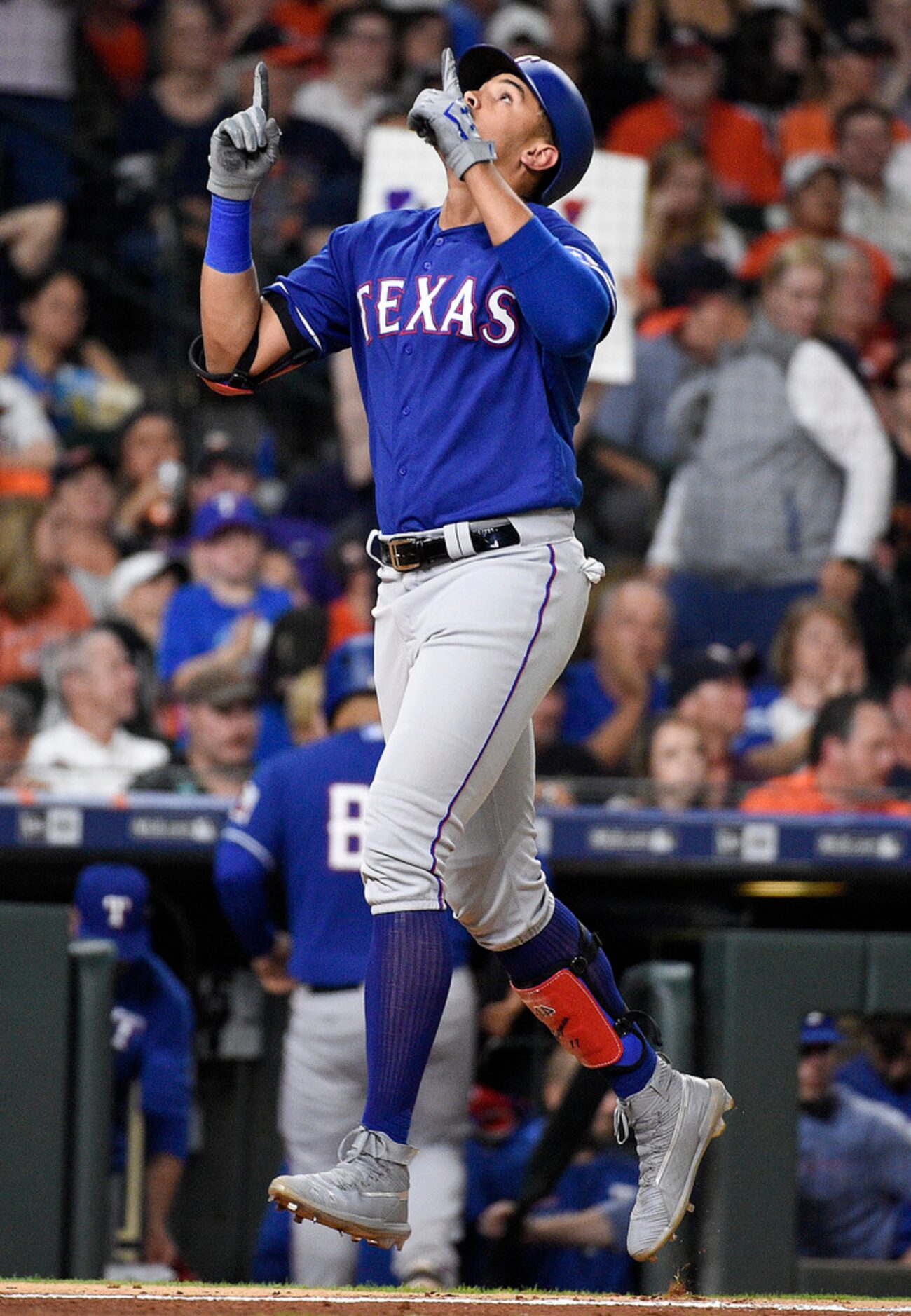 Texas Rangers' Ronald Guzman reacts after hitting a three-run home run off Houston Astros...