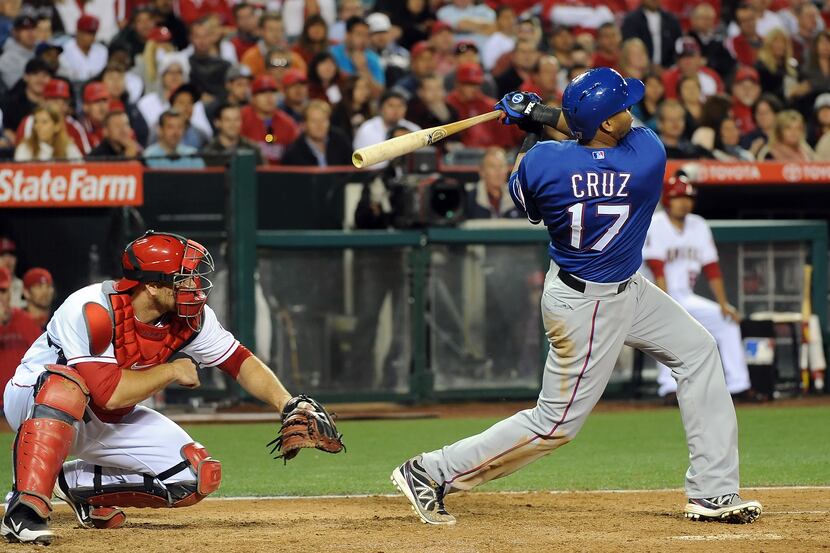 ANAHEIM, CA - APRIL 23:  Nelson Cruz #17 of the Texas Rangers hits a three run homerun in...