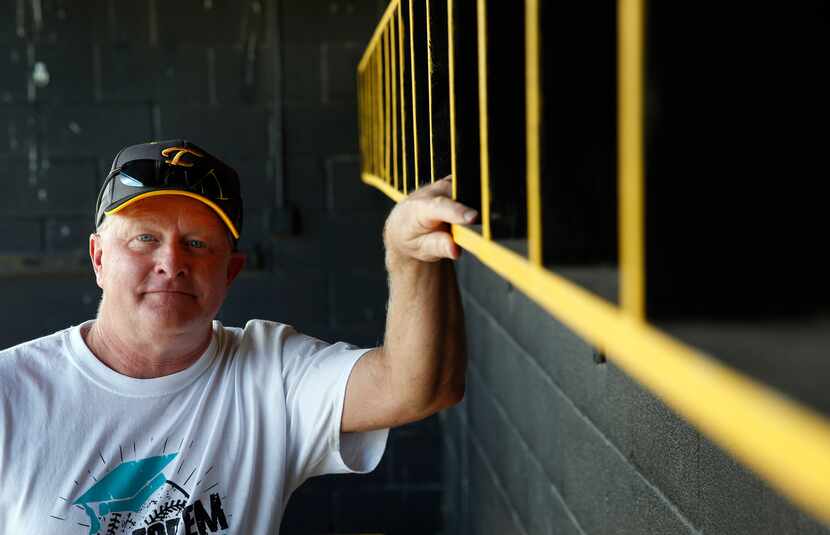 Forney High School's head softball coach Pat Eitel poses for a portrait in the dugout of...