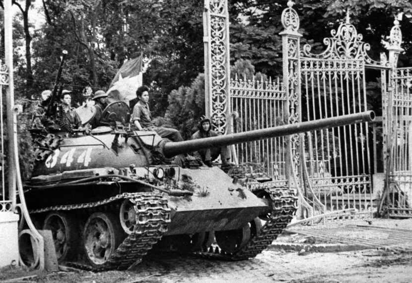 A North Vietnamese tank rolls through the gates of the Presidential Palace in Saigon,...