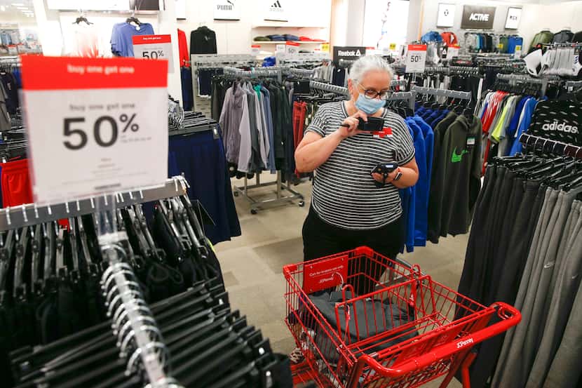Mary Wagner, a visual merchandiser at J.C. Penney, prepares a curbside order on May 1 at the...