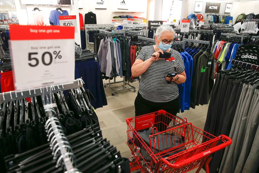 Mary Wagner, a visual merchandiser at J.C. Penney, prepares a curbside order on May 1 at the...