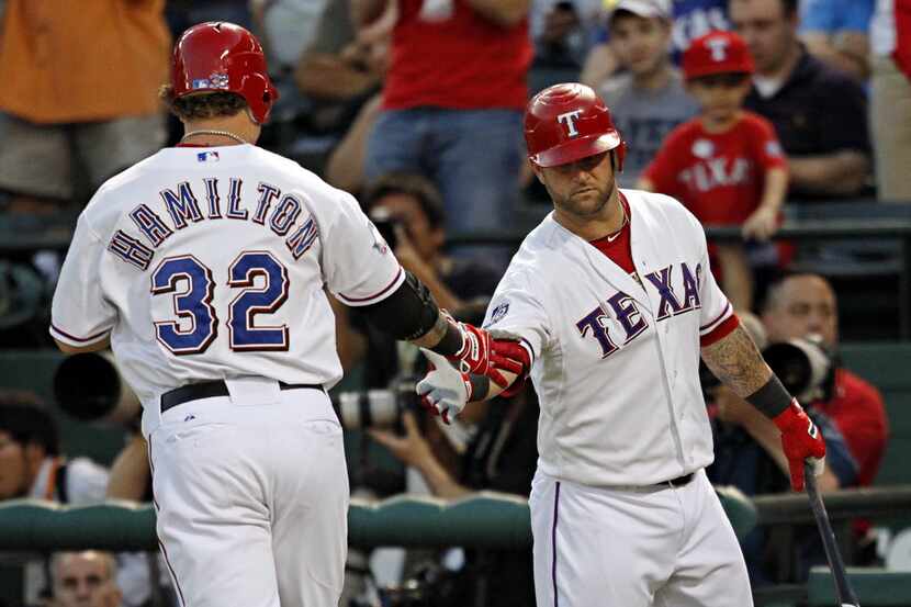 Texas Rangers catcher Mike Napoli (right) congratulates center fielder Josh Hamilton after...