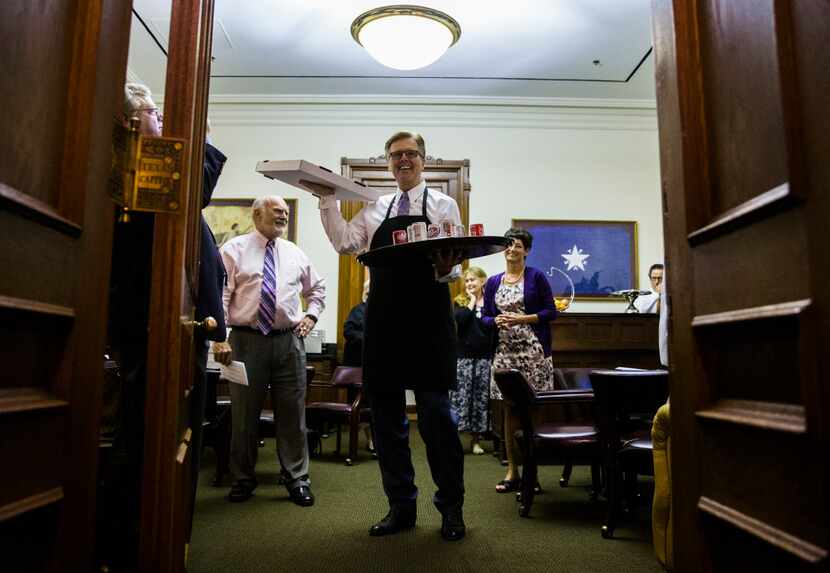 Lt. Gov. Dan Patrick holds pizza and soda inside the Senators' Room just before the Senate...