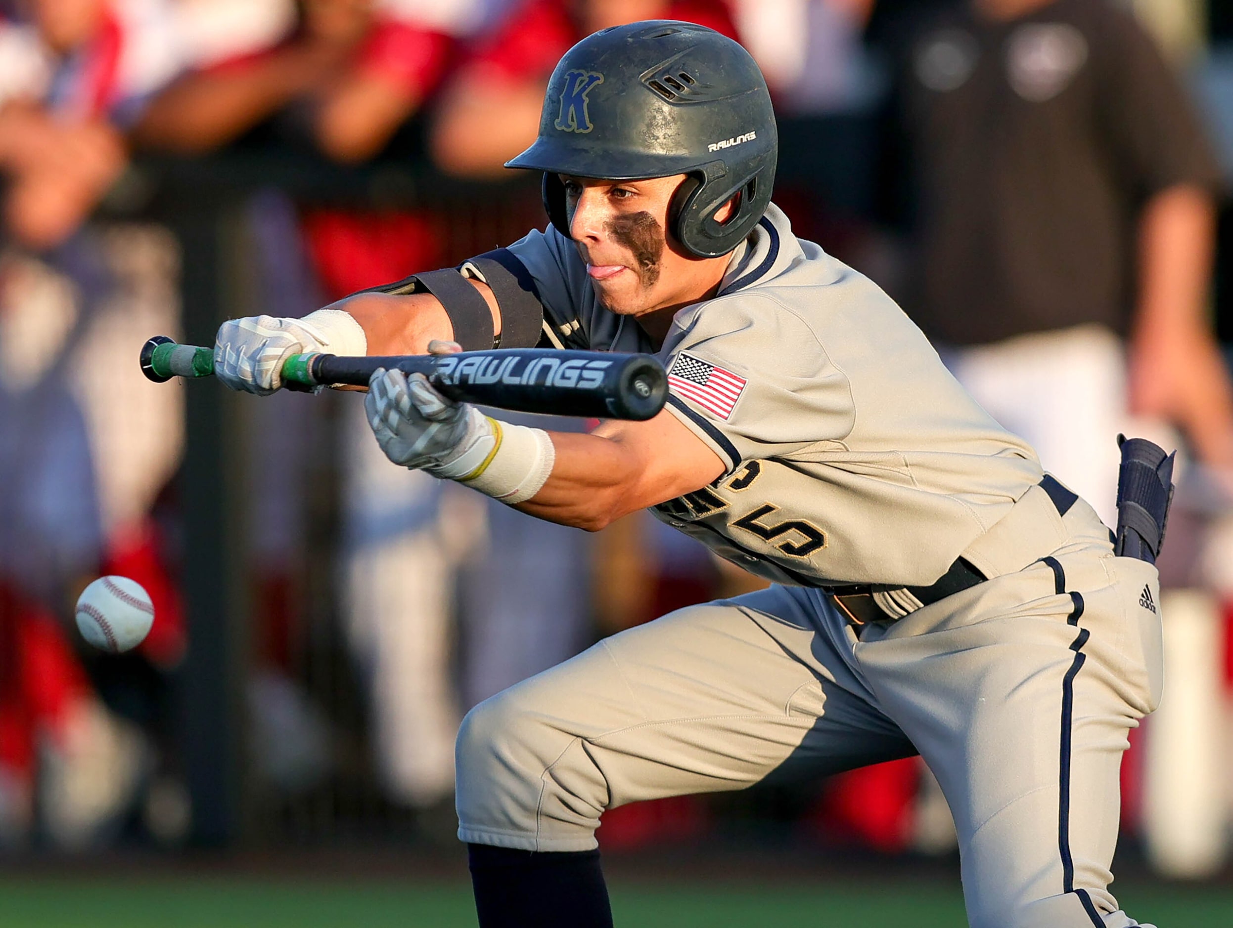 Keller center fielder Jackson Hill attempts a bunt against Flower Mound Marcus during game 1...