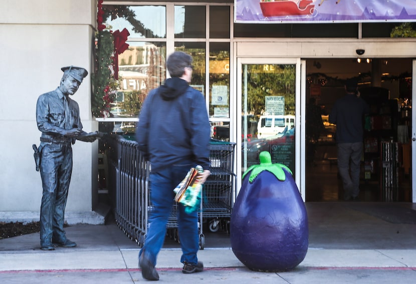 A statue of a police officer stands in front of Central Market on Lovers Lane in Dallas. A...