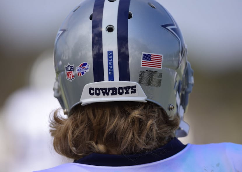Dallas Cowboys wide receiver Cole Beasley's hair sticks out the back of his helmet during...