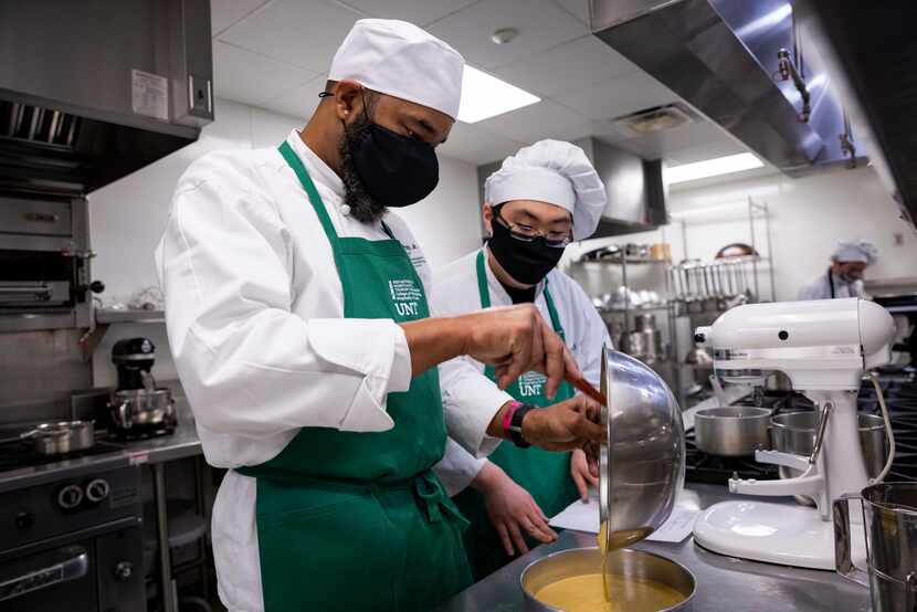 Seniors Joe McCray (left) and Richard Oh bake in the UNT culinary lab at Chilton Hall.