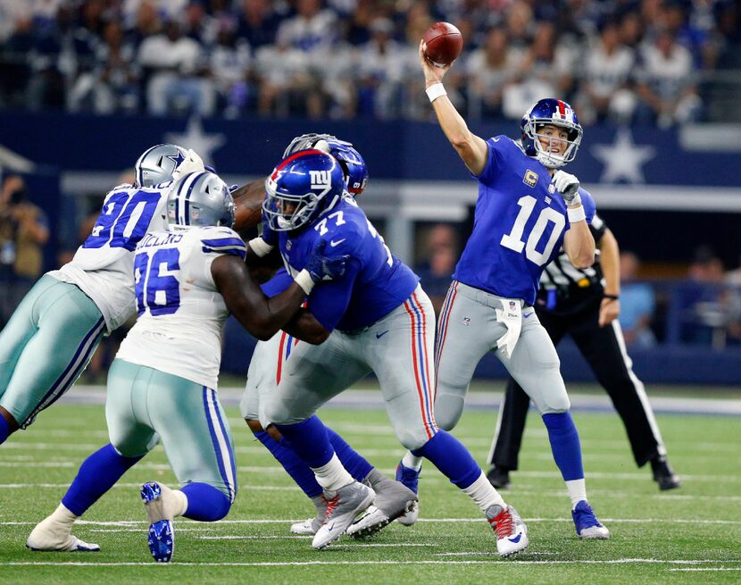 New York Giants quarterback Eli Manning (10) throws a pass from the pocket against the...