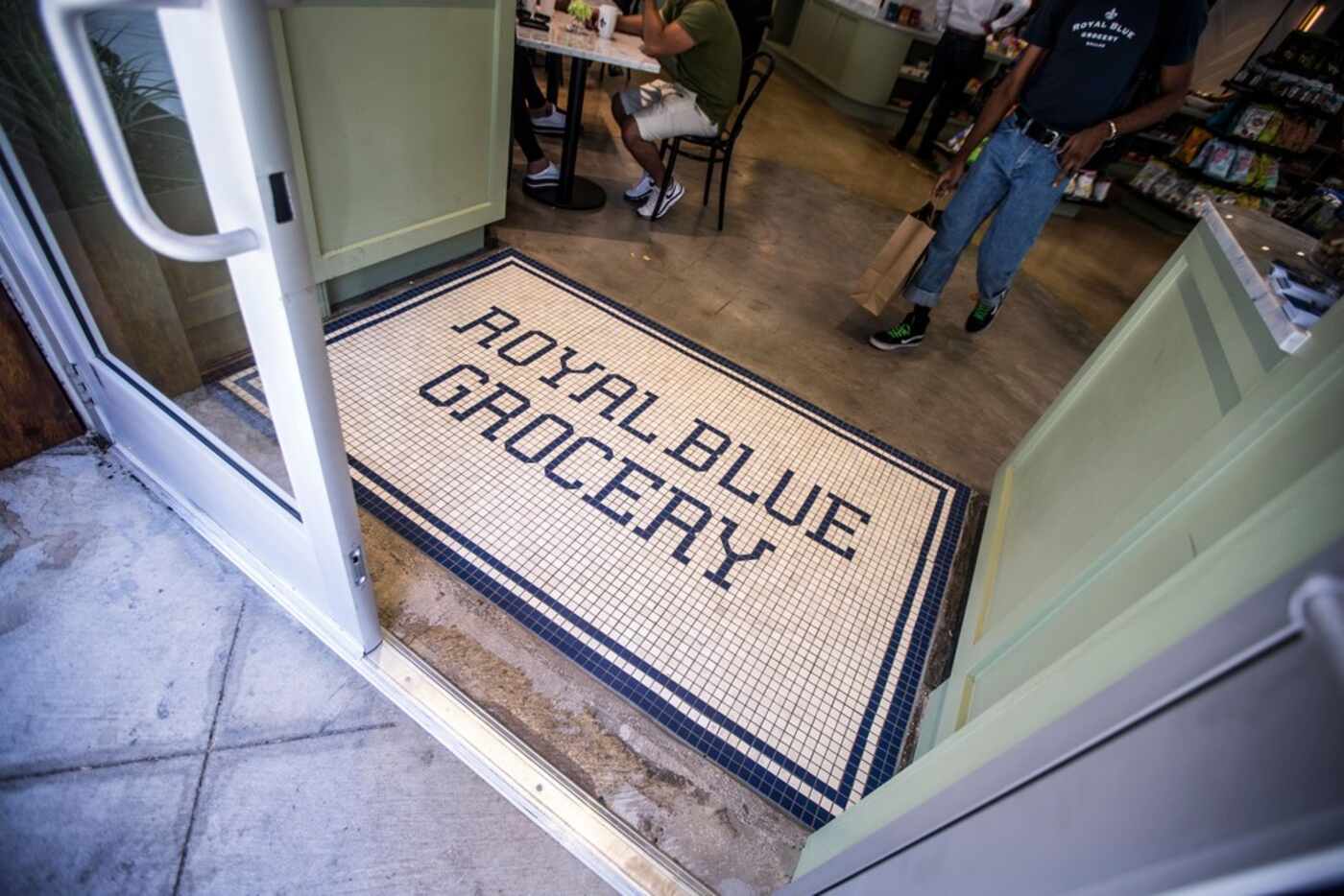 A man walks out of the store at Royal Blue Grocery in Dallas, The store opened its downtown...