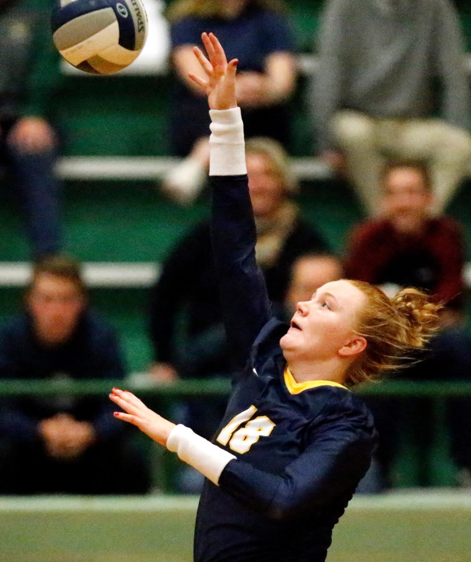 Highland Park High School outside hitter Kendyl Reaugh (18) makes a hit during game two as...