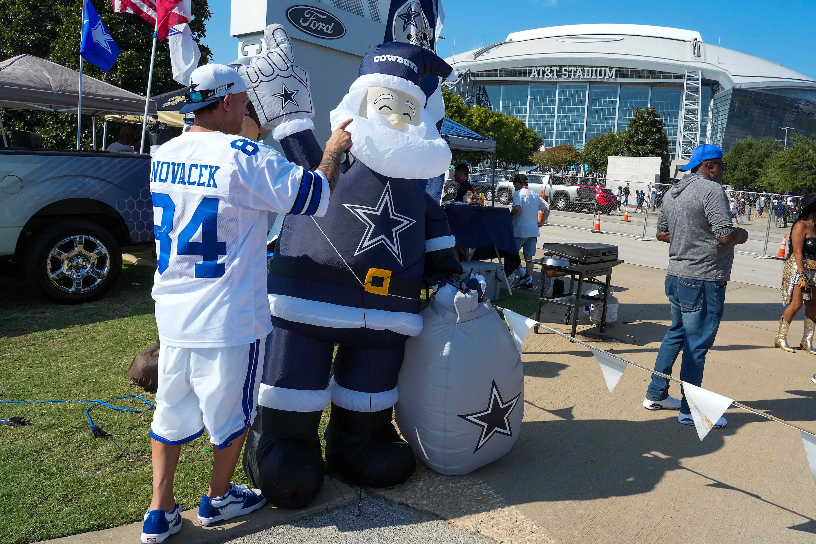 Dallas Cowboys fan Greg Courdy of Arlington tries to keep his inflatable Cowboys Santa...