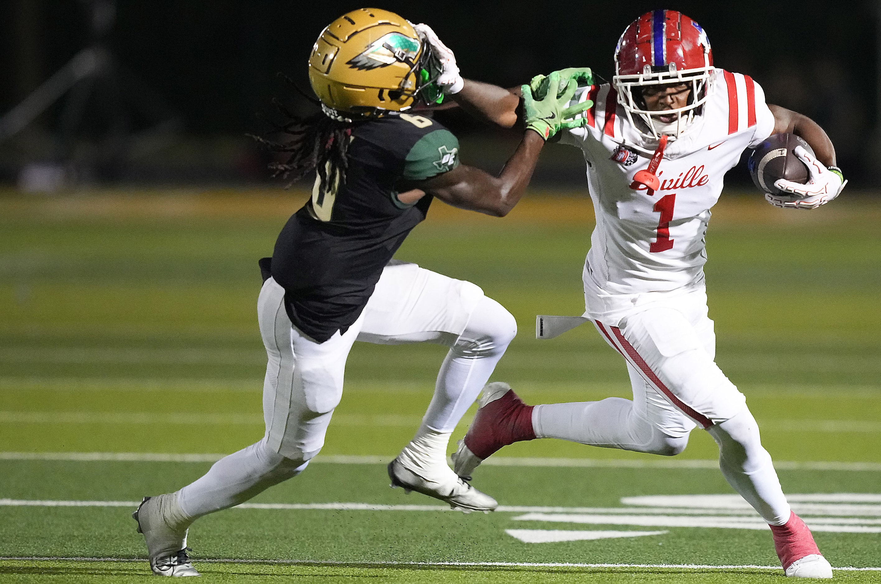 Duncanville wide receiver Dakorien Moore (1) pushes pas DeSoto defensive back Caleb Holmes...