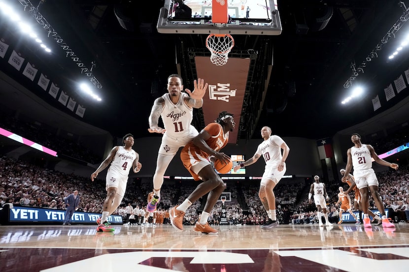 Texas forward Arthur Kaluma (6) is fouled by Texas A&M forward Andersson Garcia (11) as he...