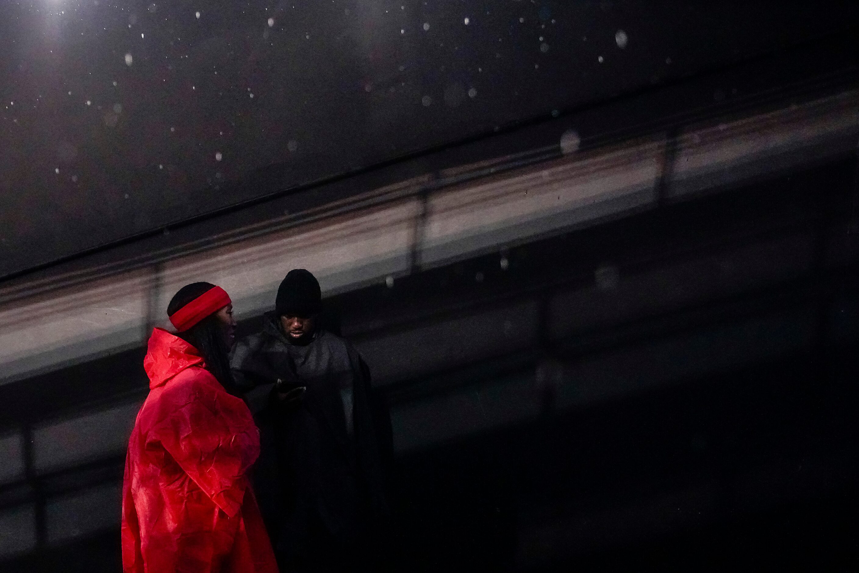 People take cover in the tunnel from the field to the locker rooms during a lightning delay...