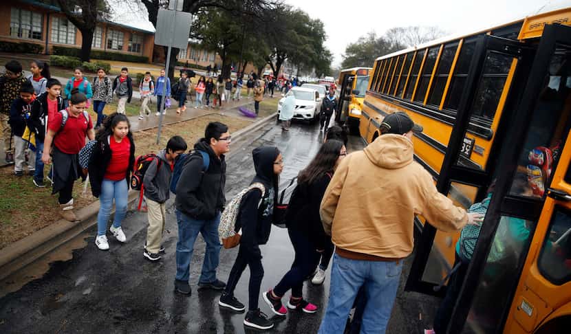 As a precaution, students from Stephen C. Foster Elementary are evacuated and loaded onto...
