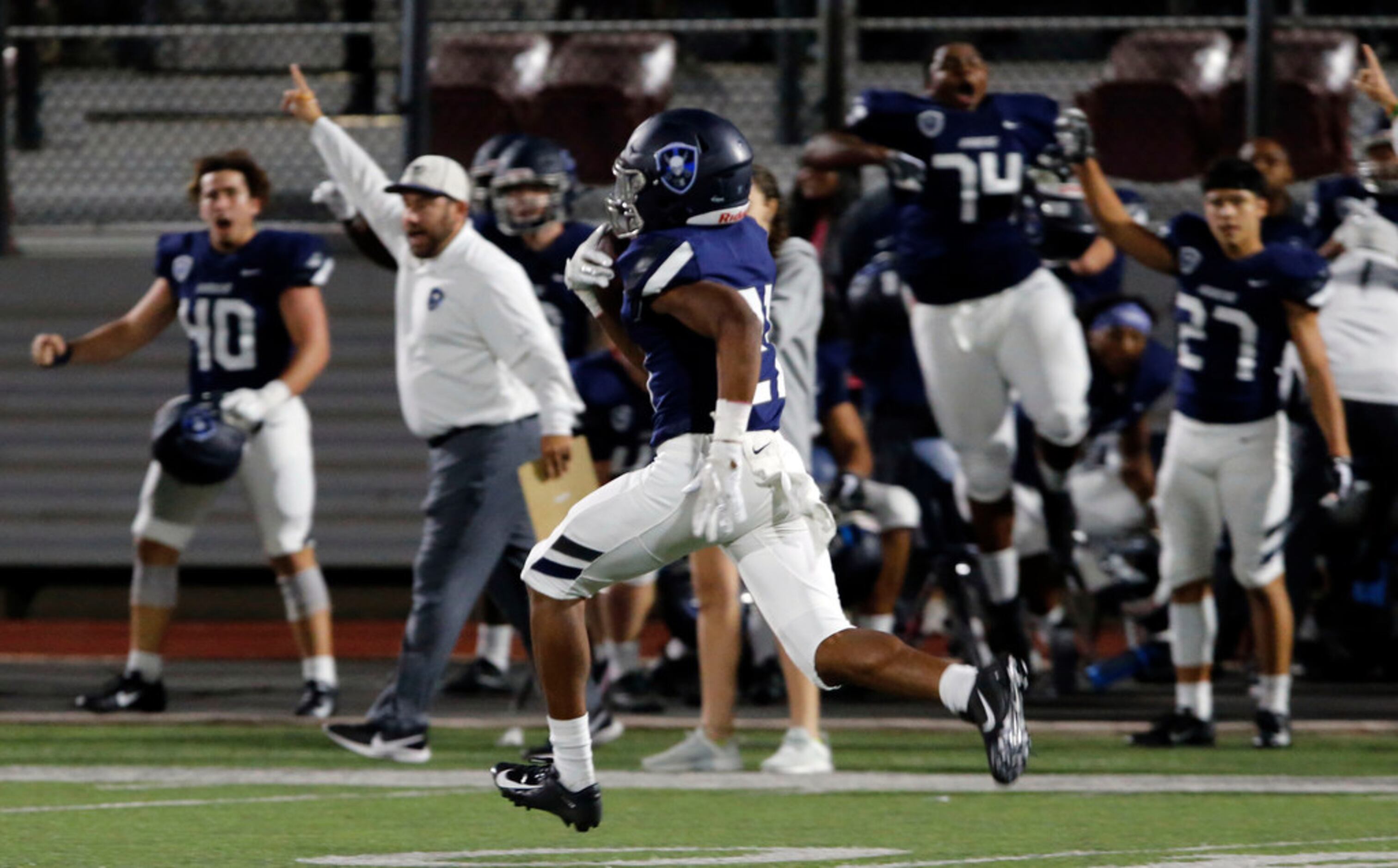 The Wylie East Bench erupts, as TJ Washington (21) takes his reception to the end zone for a...