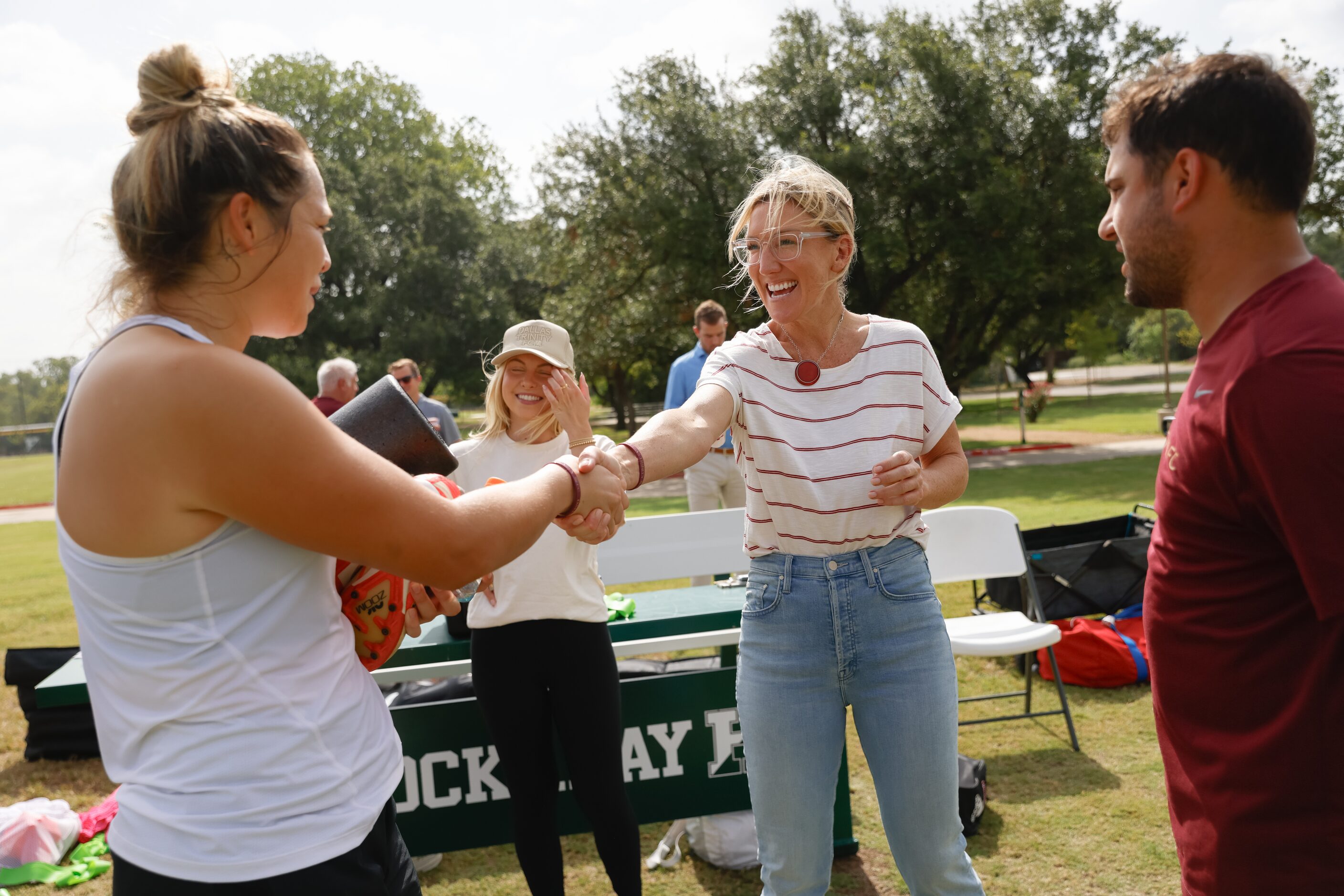 From left, Dallas Trinity FC player Sam Estrada greets USL Super League President Amanda...