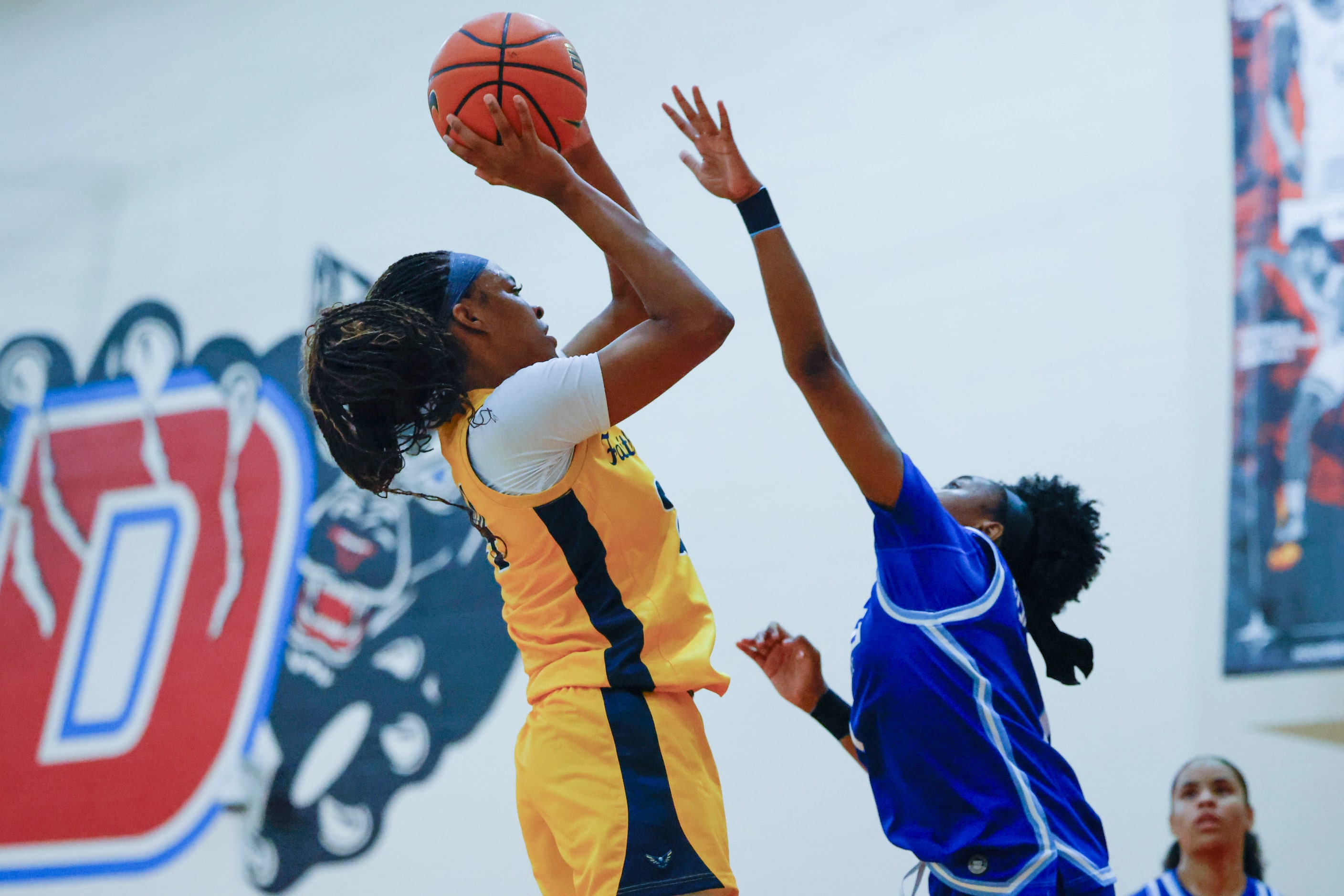 Oak Cliff Faith Family Academy’s Amari Byles (24) shoots over IMG Academy’s Kelis Fisher...