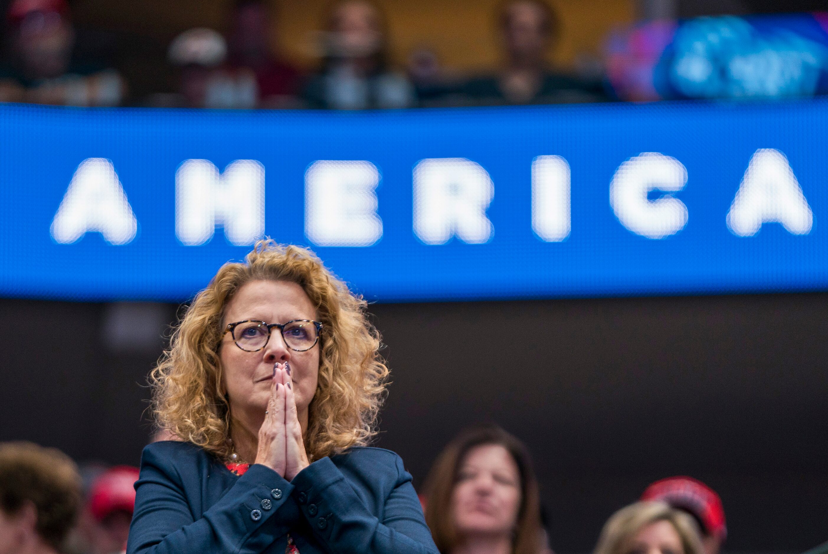 A woman listens as President Donald Trump speaks during a campaign rally at the American...