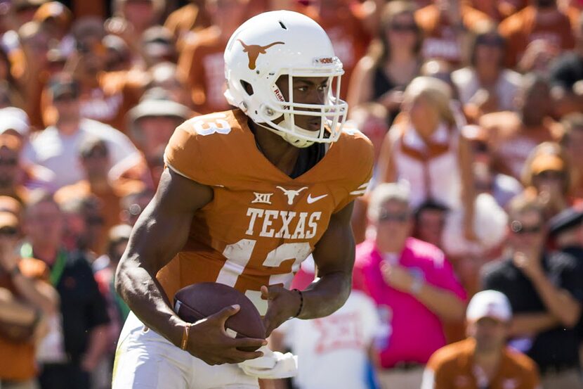 Texas quarterback Jerrod Heard (13) runs with the ball during the second half of the 2015...