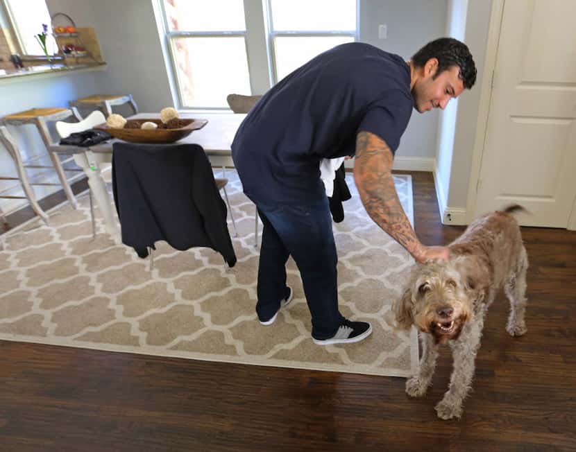 Texas Rangers relief pitcher Matt Bush is greeted by his dog Kahla as he returns home from...
