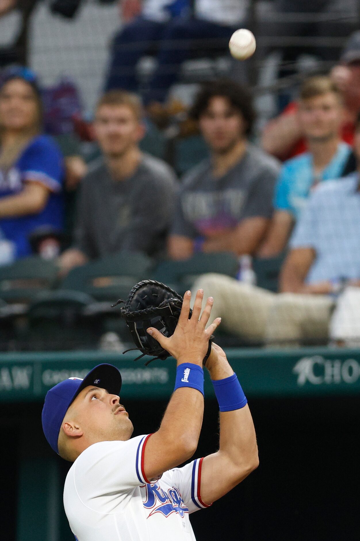 Texas Rangers first baseman Nathaniel Lowe (30) catches a fly ball in foul territory for an...