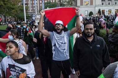 Palestinian supporters chant as they march during a protest at Columbia University,...