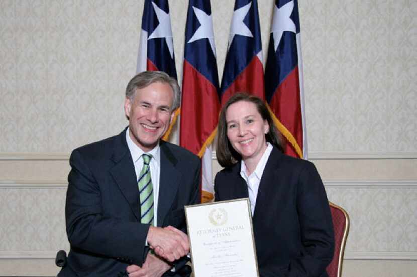 As attorney general in 2008, Greg Abbott presented Martha Fitzwater Pigott with an award....