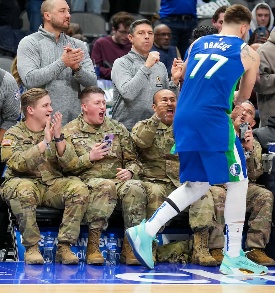 Dallas Mavericks guard Luka Doncic (77) fist bumps court side fans on Seats for Soldiers...