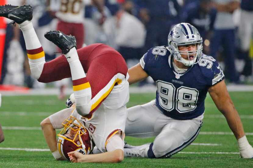Dallas Cowboys defensive end Tyrone Crawford (98) sends Washington Redskins quarterback Kirk...