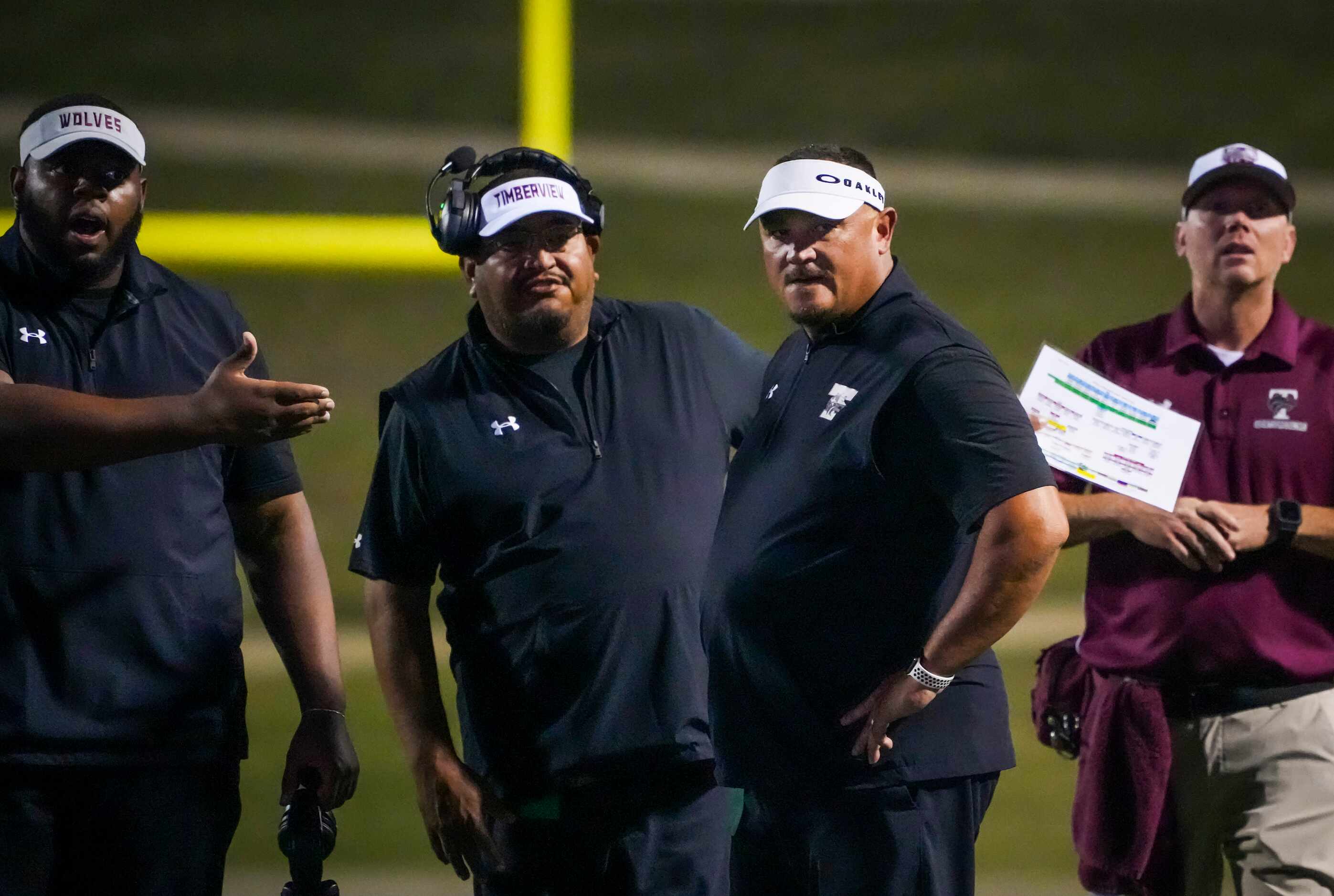 Mansfield Timberview head coach James Brown (second from right) reacts to a call during the...