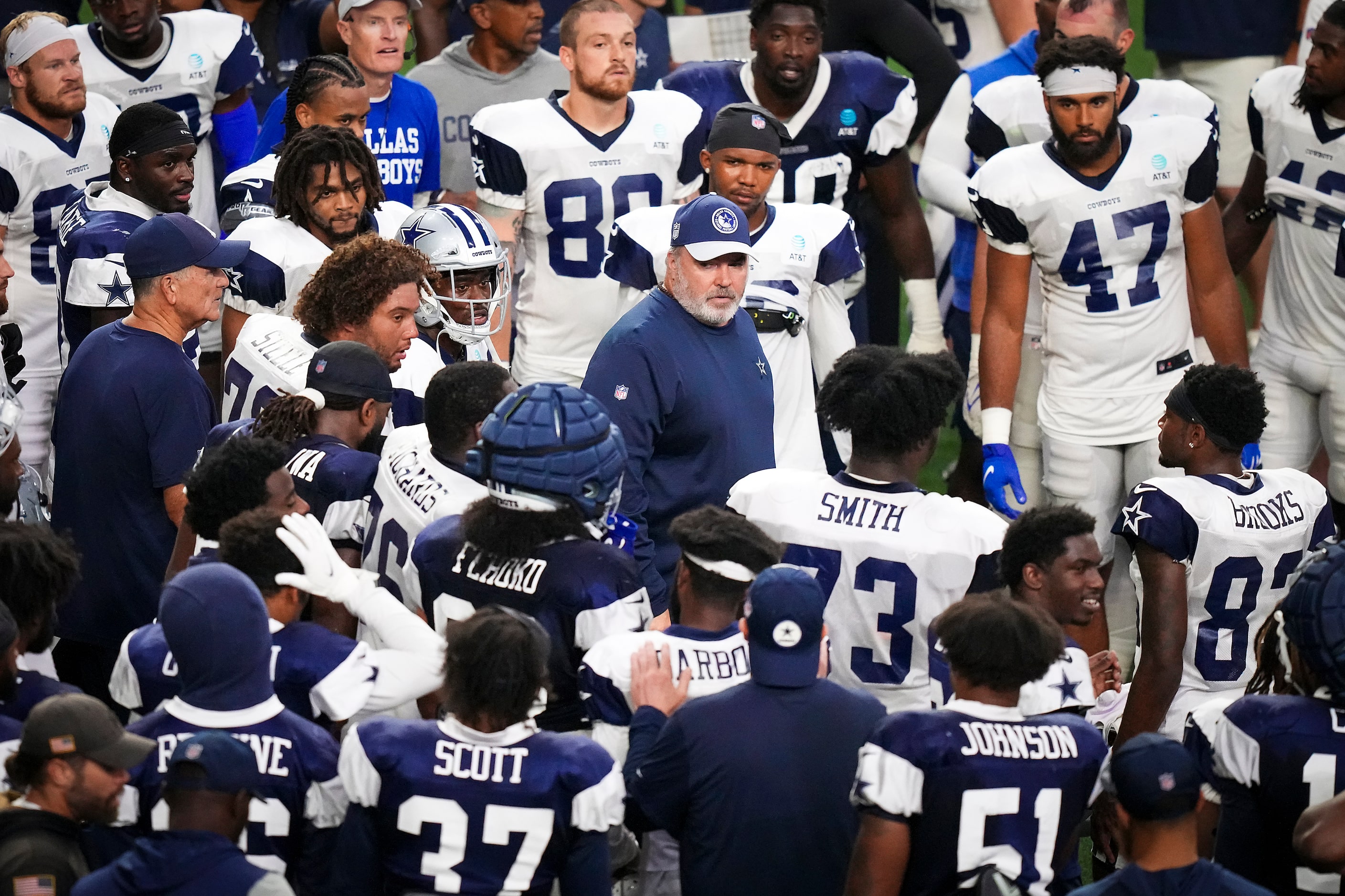 Dallas Cowboys players huddle around head coach Mike McCarthy during the team’s first public...