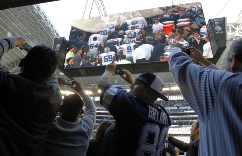 Several businessmen from Mexico gather in the Miller Club trying to get a better view of the...