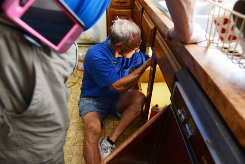 Plain-O Helper Irv Stone replaces the kitchen faucet at a Plano home.