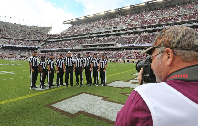 The SEC officiating crew breaks gets a group photo made before opening kickoff during the ...