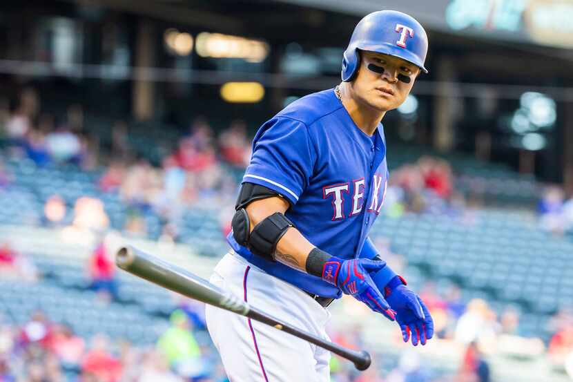 Texas Rangers right fielder Shin-Soo Choo heads for first base after being hit by a pitch...