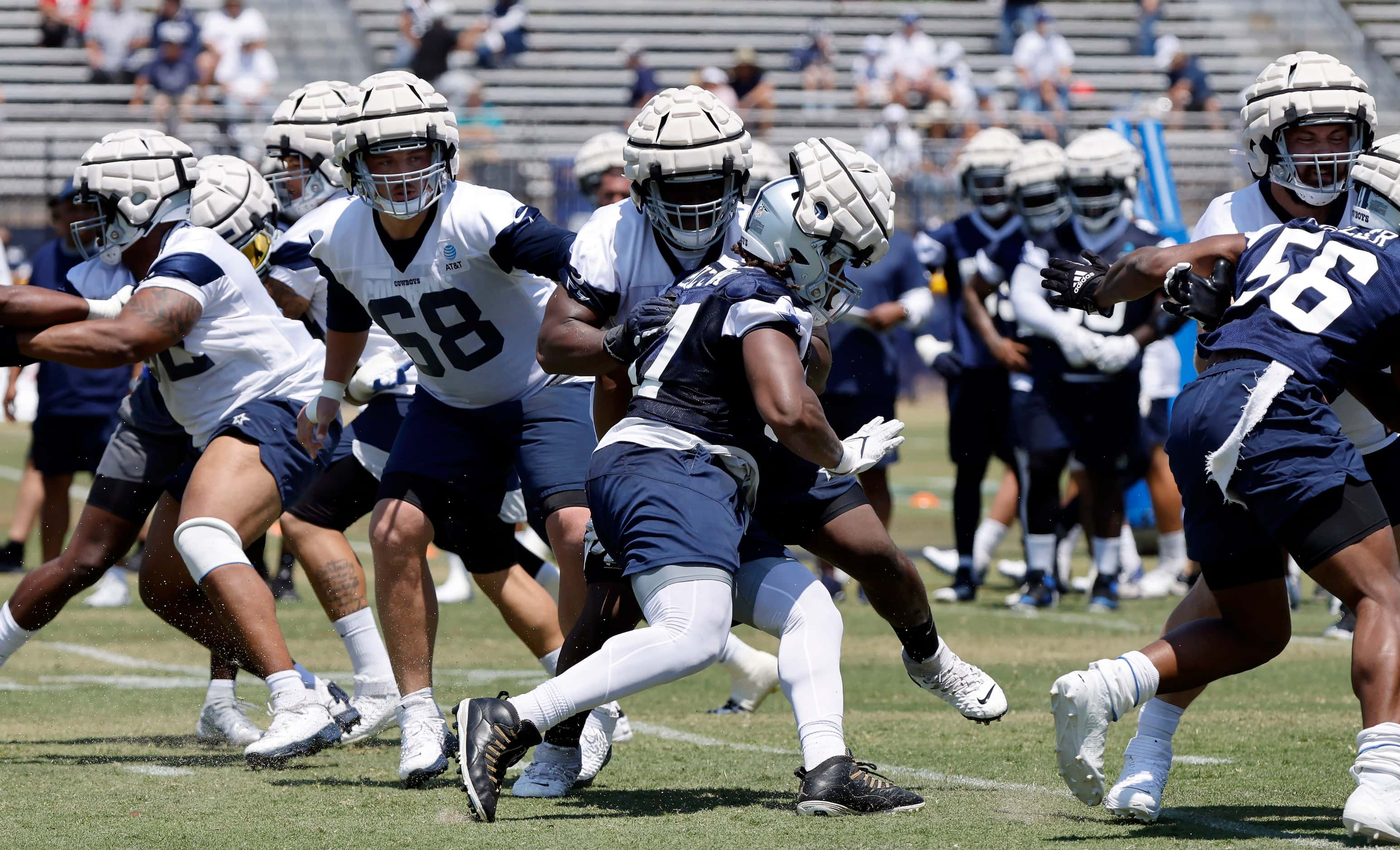 Dallas Cowboys lineman on both sides of the ball wear Guardian Caps over their helmets for...