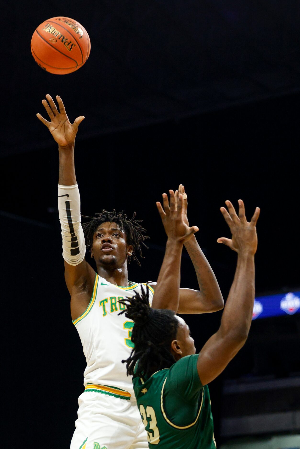 Madison forward Leonard Miles IV (3) launches a shot over San Antonio Cole center Kenny...