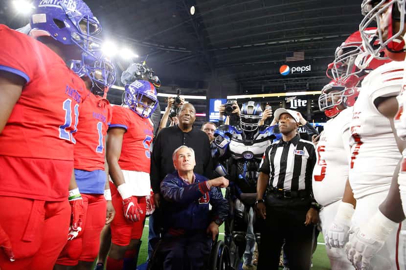 Texas State Govenor Greg Abbott flips the coin before Duncanville's game with Galena Park...