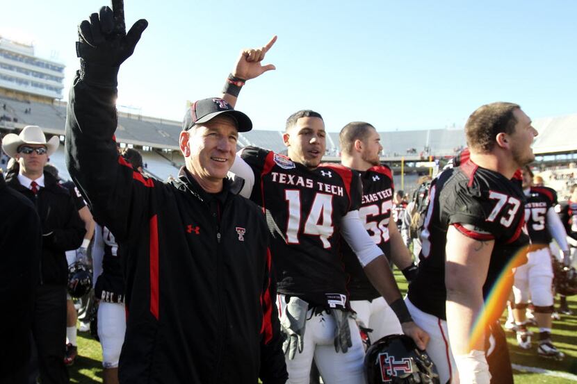 Texas Tech head coach Tommy Tuberville celebrates with his players as the school song is...
