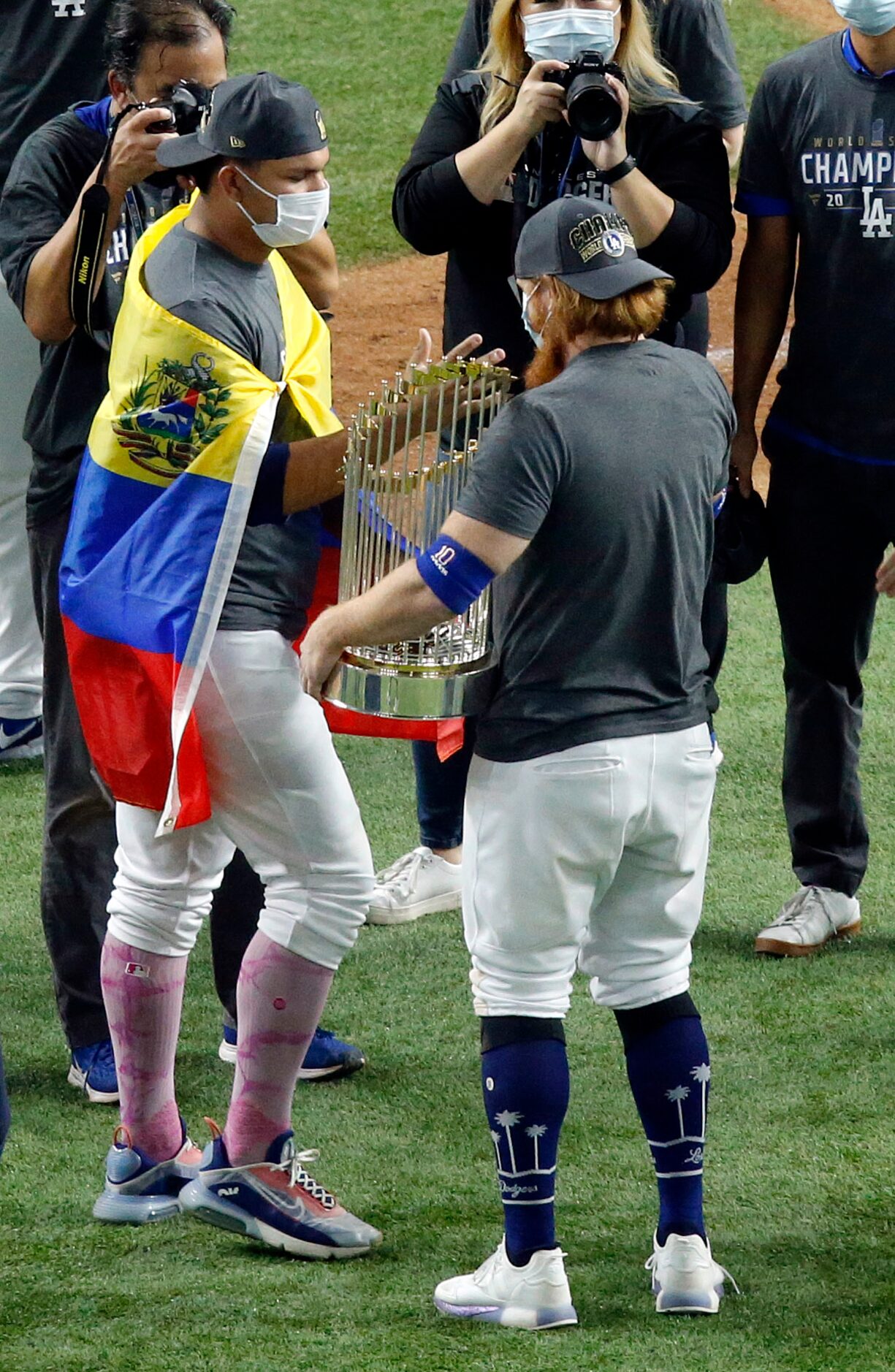 Los Angeles Dodgers third baseman Justin Turner (right, with trophy) receives...