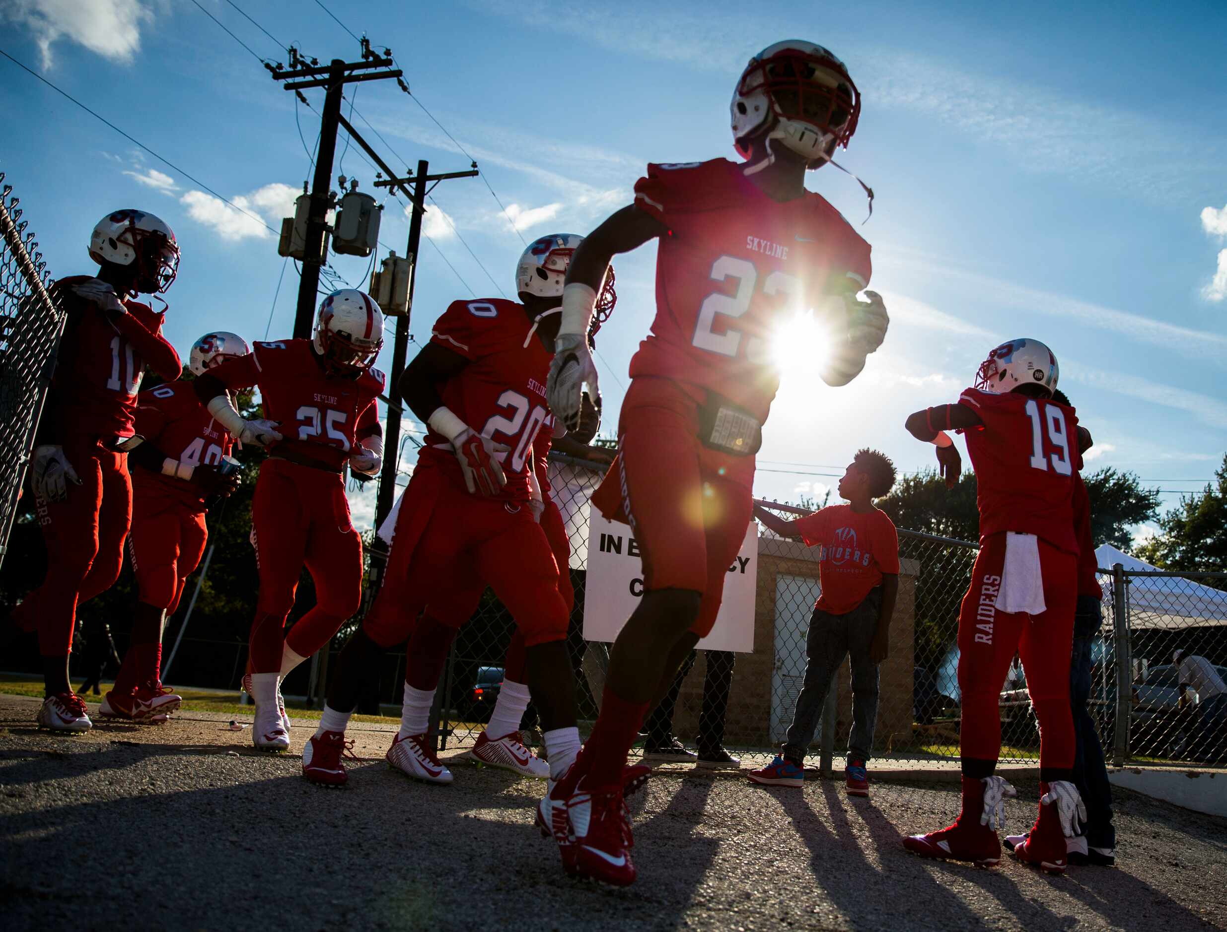 Arlington Martin football players take the field to warm up before their game against the...