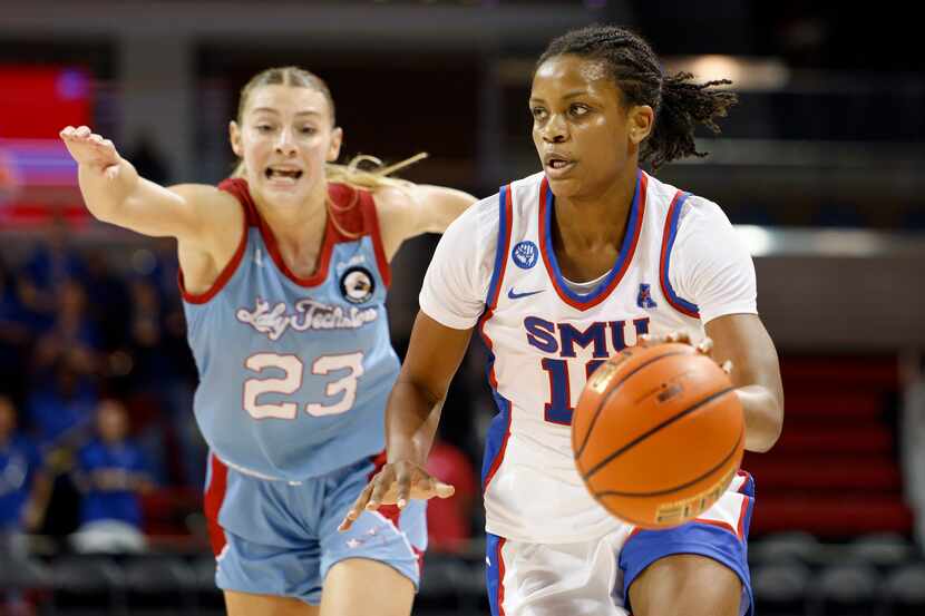 SMU guard Jasmine Smith (10) pushes the ball up court ahead of Louisiana Tech guard Silvia...